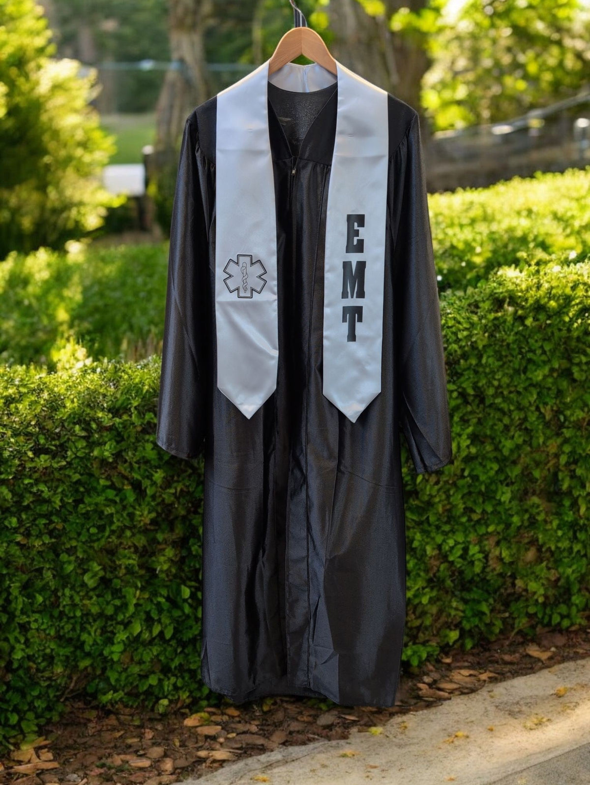 Rocky Mountain Balfour black graduation gown with white EMT stole featuring Star of Life emblem and EMT lettering